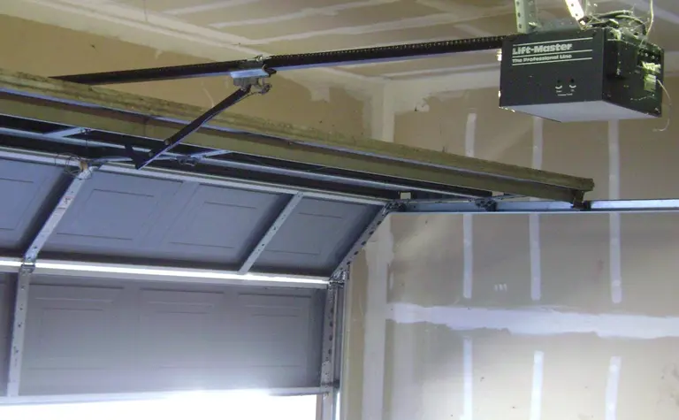 A chain-drive garage door opener, rail and sectional garage door