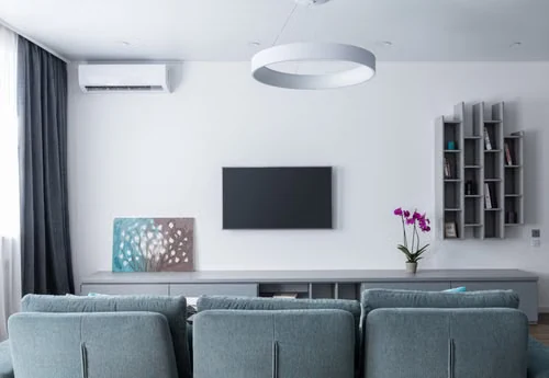 Wall-mounted ductless mini-split indoor unit serving a finished living room