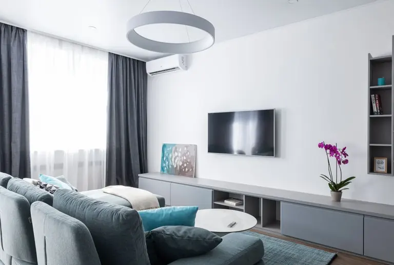 Wall-mounted indoor heat-pump unit in a living room